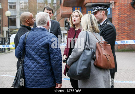 Home Secretary Amber Rudd (3rd right) with Wiltshire Police Assistant Chief Constable Kier Pritchard (right) and MP for Salisbury and South Wiltshire John Glen (back) speak with local business owners as they visit the scene at the Maltings shopping centre in Salisbury where former Russian double agent Sergei Skripal and his daughter were found critically ill after exposure to a nerve agent. Stock Photo