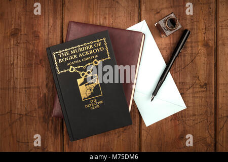 The Murder of Roger Ackroyd, detective novel by Agatha Christie, with leather journal, blue envelope, and ink pen and well Stock Photo