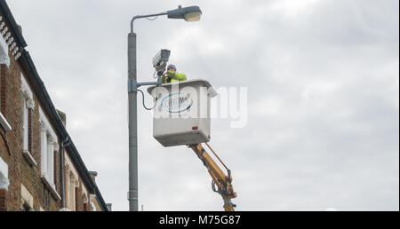 A CCTV camera being installed by a maintenance crew in Earlsfield, London Stock Photo