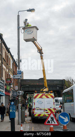A CCTV camera being installed by a maintenance crew in Earlsfield, London Stock Photo