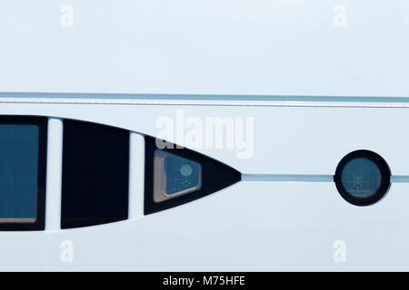 Super yacht side with circle, triangular shape windows on white background, abstract scene . Stock Photo