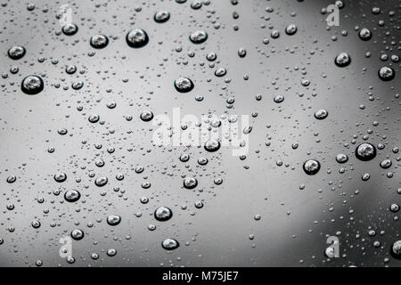 Raindrops Beaded on glass Forming an abstract pattern Stock Photo