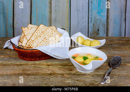 Traditional Jewish matzah ball soup, dumplings made from matzah meal ground matzo. Stock Photo