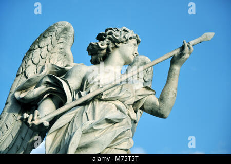 Marble statue of angel holding the Holy Lance of Longinus. Sant'Angelo bridge balustrade. Rome, Italy Stock Photo