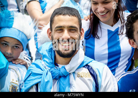 Argentinian football fan smiling at match, portrait Stock Photo