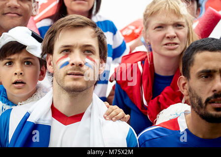 French football fans watching match attentively Stock Photo