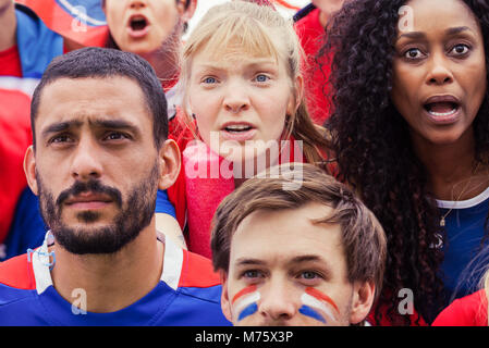 French football fans anxiously watching match Stock Photo