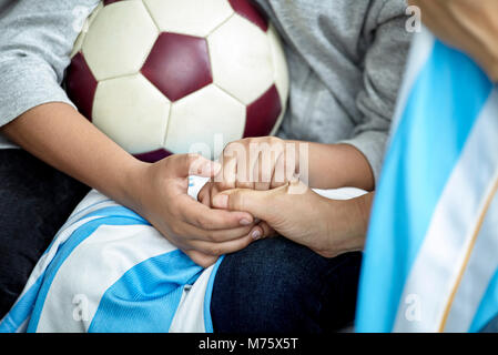 Child holding soccer ball, cropped Stock Photo