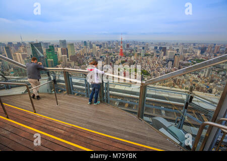Tokyo, Japan - April 20, 2017: people standing on skydeck of Mori Tower, the modern skyscraper and tallest building of the Roppongi Hills complex, Minato Tokyo. Stock Photo