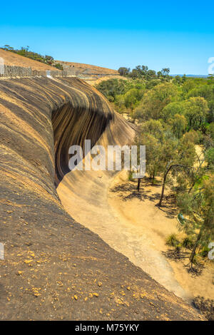 Aerial view from top of famous place of Wave Rock, Australian outback, near Hyden, Western Australia. The natural rock formation is shaped like a tall ocean wave in Hyden Wildlife Park. Vertical shot. Stock Photo