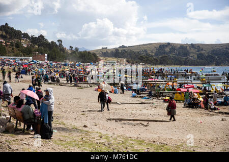 COPACABANA, BOLIVIA - JANUARY 6, 2018: Unindentified people on lake Titicaca shore in Copacabana, Bolivia. Copacabana is the main Bolivian town on the Stock Photo