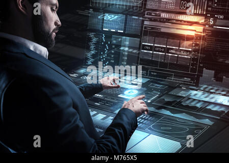 Attentive programmer working carefully while being in his office Stock Photo