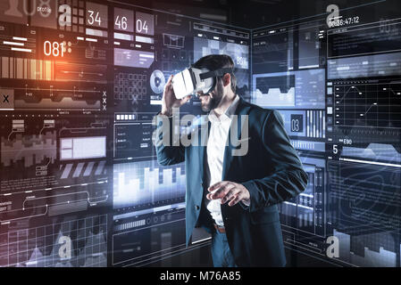 Progressive specialist wearing virtual reality glasses while working Stock Photo