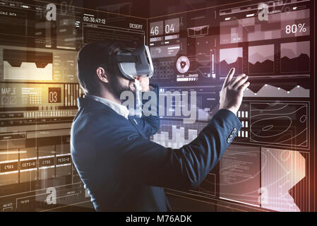 Cheerful specialist smiling while wearing virtual reality device Stock Photo