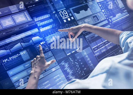 Confident specialist pointing to the screen while making necessary changes Stock Photo
