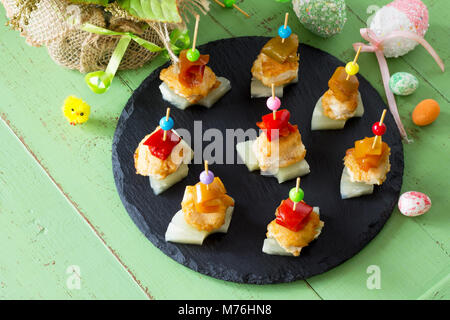Easter recipe, festive appetizer. Canapes with pineapple, grill chicken, marinated peppers - on the festive table. Stock Photo