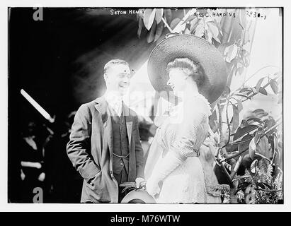 This image shows Seton Henry and Miss C. Harding in a three-quarter view, standing and engaging in conversation. The photograph captures a candid moment between two individuals, likely in a social setting of the time. Stock Photo