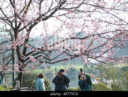 Wuhan, China's Hubei Province. 9th Mar, 2018. Tourists take pictures of cherry blossoms in the Donghu Scenic Area in Wuhan, central China's Hubei Province, March 9, 2018. Credit: Xiong Qi/Xinhua/Alamy Live News Stock Photo