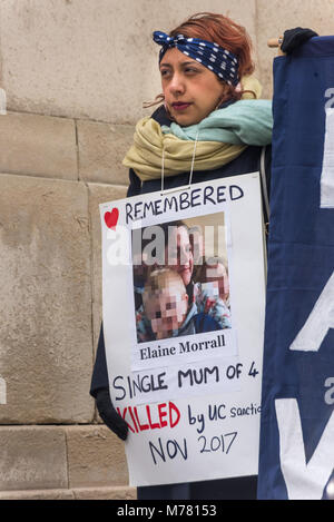 London, UK. 8th March 2018. A woman holds a poster about single 'mum of 4' Elaine Morrall kiled by Universal Credit sanctions in November 2017 at the Global Women's Strike mock trial of the Family Courts in an International Women’s Day protest in front of Parliament. Speakers included mothers who have had children unjustly removed and others who read out shocking comments made in court by judges. The UK has the highest rate of adoptions in Europe, almost all without consent of their birth family. In some working class areas, 50% of children are referred to social services and that families of  Stock Photo