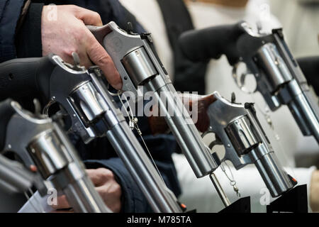 09 March 2018, Germany, Nuremberg: A visitor holding a revolver by the American manufacturer Smith & Wesson (S&W) at the IWA OutdoorClassics trade show for hunting, shooting sports, equipment for outdoor activities and for civilian and official security applications. Photo: Daniel Karmann/dpa Stock Photo