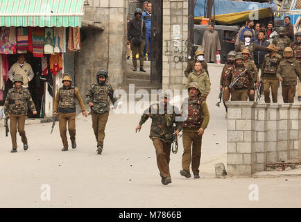 Srinagar, Jammu and Kashmir, India. 9th Mar, 2018. Indian policemen chasing away pro freedom protesters in old city Srinagar the summer capital of Indian controlled Kashmir. Government imposed restrictions in many parts of south Kashmir to prevent protest against the recent killing of civilians by Indian army in a shootout in Pahnoo, Shopian. Credit: Faisal Khan/ZUMA Wire/Alamy Live News Stock Photo