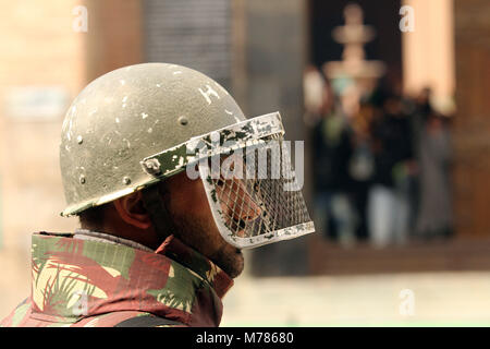 Srinagar, Jammu and Kashmir, India. 9th Mar, 2018. An Indian policeman looks on during a protest in old city Srinagar the summer capital of Indian controlled Kashmir. Government imposed restrictions in many parts of south Kashmir to prevent protest against the recent killing of civilians by Indian army in a shootout in Pahnoo, Shopian. Credit: Faisal Khan/ZUMA Wire/Alamy Live News Stock Photo