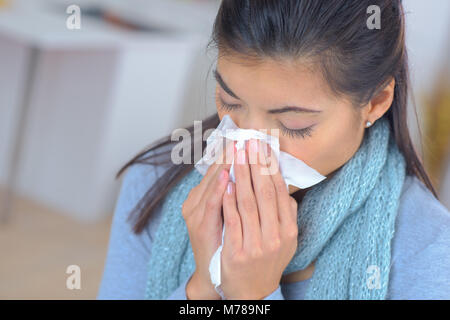 woman feeling sick and sneezing Stock Photo