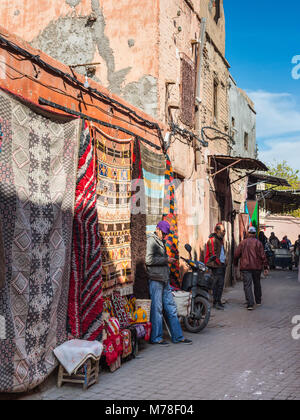 Marrakesh, Morocco - December 8, 2016: Street textile merchants in the famous souks of Marrakesh, Morocco, Africa. Stock Photo