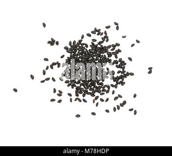Small black aquilegia flower seeds - columbine - scattered on a white background Stock Photo