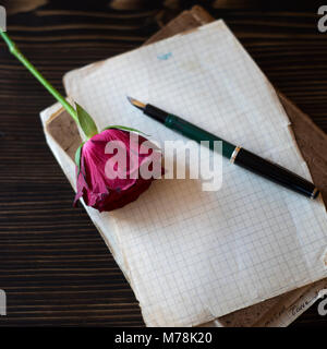 Blank paper sheets on old wooden table, love story Stock Photo