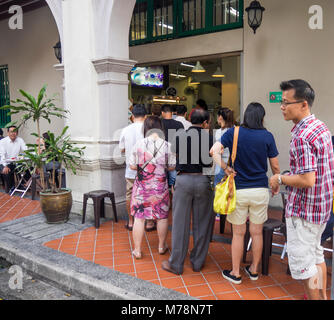 Local Singaporeans queuing out a popular traditional Singapore restaurant, YY Kafei Dian, for breakfast. Stock Photo