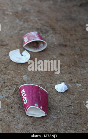 Coffee cups left on the ground as litter. Stock Photo