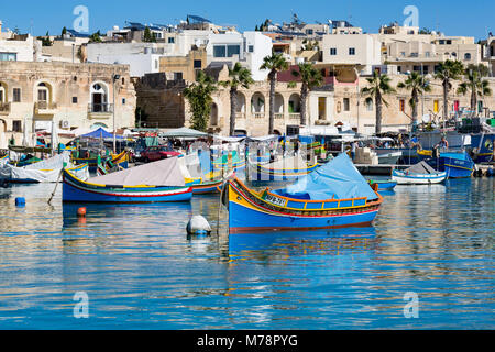 Traditional brightly painted fishing boats in the harbour at Marsaxlokk, Malta, Mediterranean, Europe Stock Photo