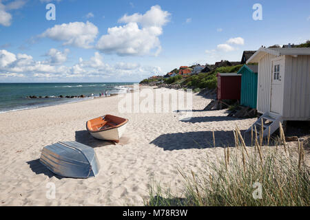 Boats and beach huts on white sand beach with town behind, Tisvilde, Kattegat Coast, Zealand, Denmark, Scandinavia, Europe Stock Photo