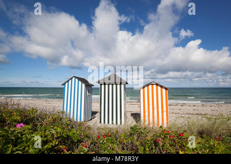 Colourful beach huts on pebble beach with blue sea and sky with clouds, Rageleje, Kattegat Coast, Zealand, Denmark, Scandinavia, Europe Stock Photo