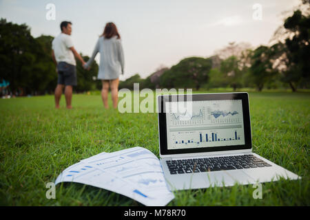 The couple checking reported profits in the garden. Stock Photo
