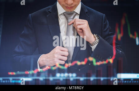 Double exposure, Businessman tying necktie with raising graph diagram background. Business growth and investment Stock Photo