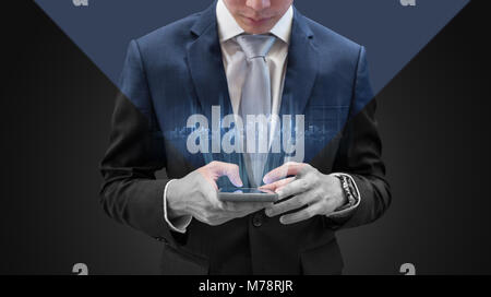 Young businessman using mobile smart phone, with futuristic buildings hologram Stock Photo