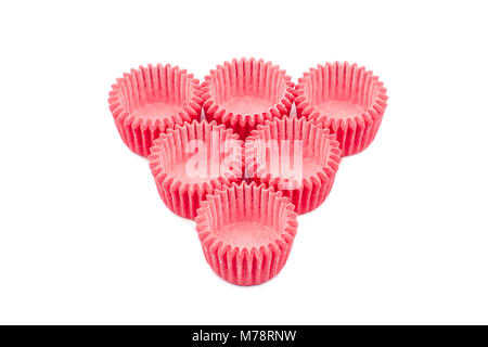 horizontal top view of arrangement of many pink small paper baking tray holders for cupcakes and muffin isolated on white background Stock Photo