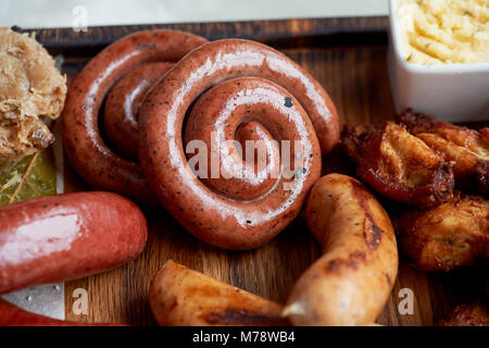 German hearty lunch in the pub.Grilled sausages, stewed cabbage, croutons, sauce. Beer snack Stock Photo