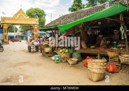 Burmese Asian market Nyaung U near Bagan, Myanmar. Market stall selling fruit, vegetables and nuts with products on display in crates and cane basket. Stock Photo