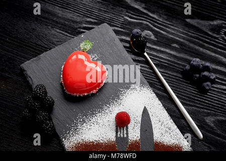 Massovoe cake red heart-shaped dessert on a date.Sprinkled with cocoa and powder. Stock Photo