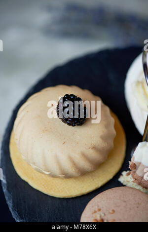 Cakes on a dark slate bunk stand.Desserts. Sweet table Stock Photo