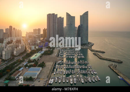 Busan city skyline view at Haeundae district, Gwangalli Beach with yacht pier at Busan, South Korea. Stock Photo