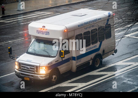 An Access-A-Ride vehicle waits for their passenger during inclement weather in the Chelsea neighborhood of New York on Thursday February 22, 2018. According to a recently released audit by the New York City Comptroller's office almost half of complaints by users about Access-A-Ride are either ignored or only investigated cursorily. Access-A-Ride, a unit of the MTA, provides transportation services to the disabled and elderly who cannot use the subway or bus system. (Â© Richard B. Levine) Stock Photo