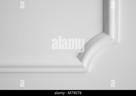 Decorative item made of white plaster on ceiling. Relief stucco interior Stock Photo