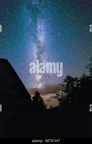 Old Barns and outbuildings with starry sky with clouds and milky way in ...