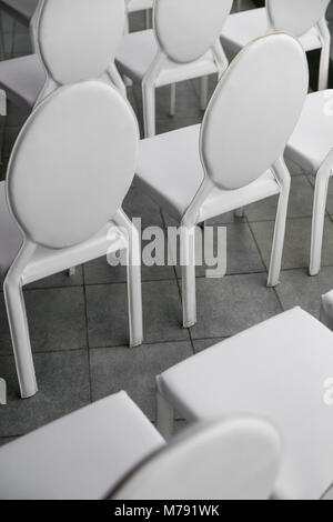 background of row of white seats. Empty chairs in the conference hall. Stock Photo