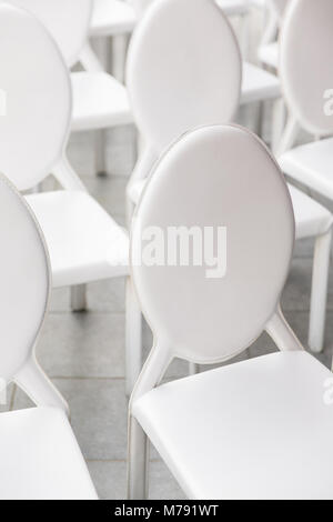 background of row of white seats. Empty chairs in the conference hall. Stock Photo