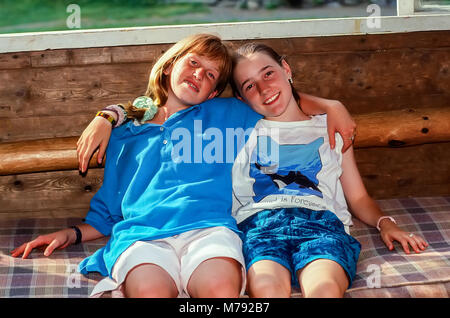 Two happy girl children hugging in friendship at summer camp in Vermont, United States, North America. Stock Photo